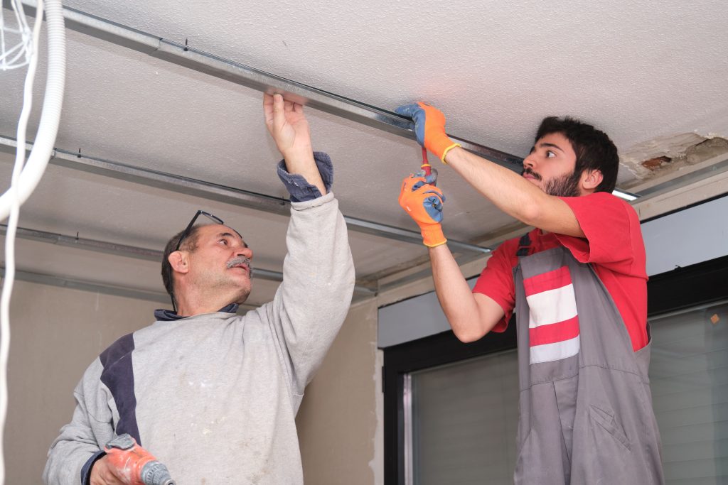 men working on garage door mechanism