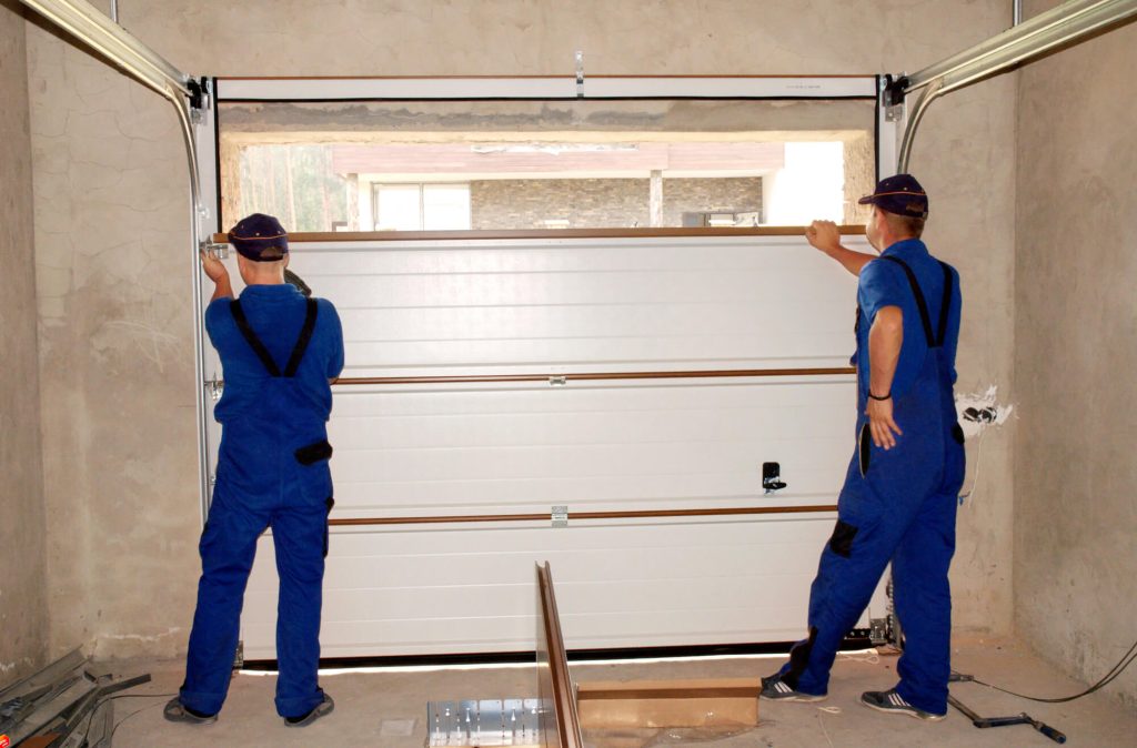 two repairman fixing garage