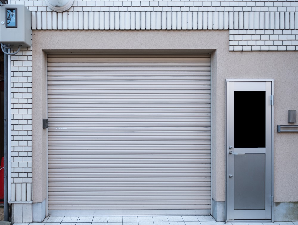 Garage with door residence on white brick in suburb area