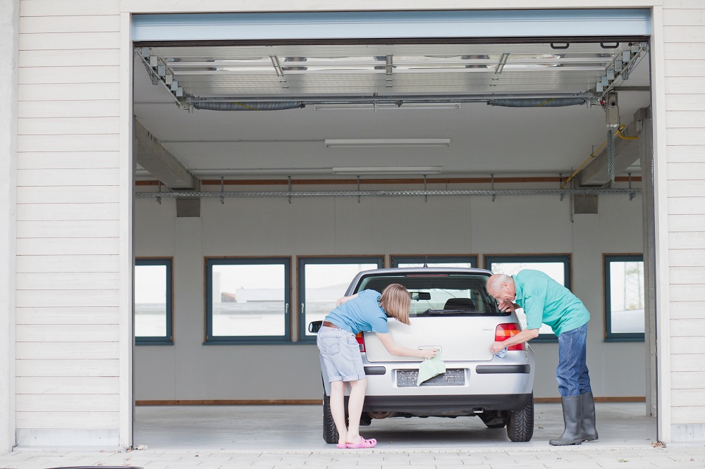 old man and young girl washing car