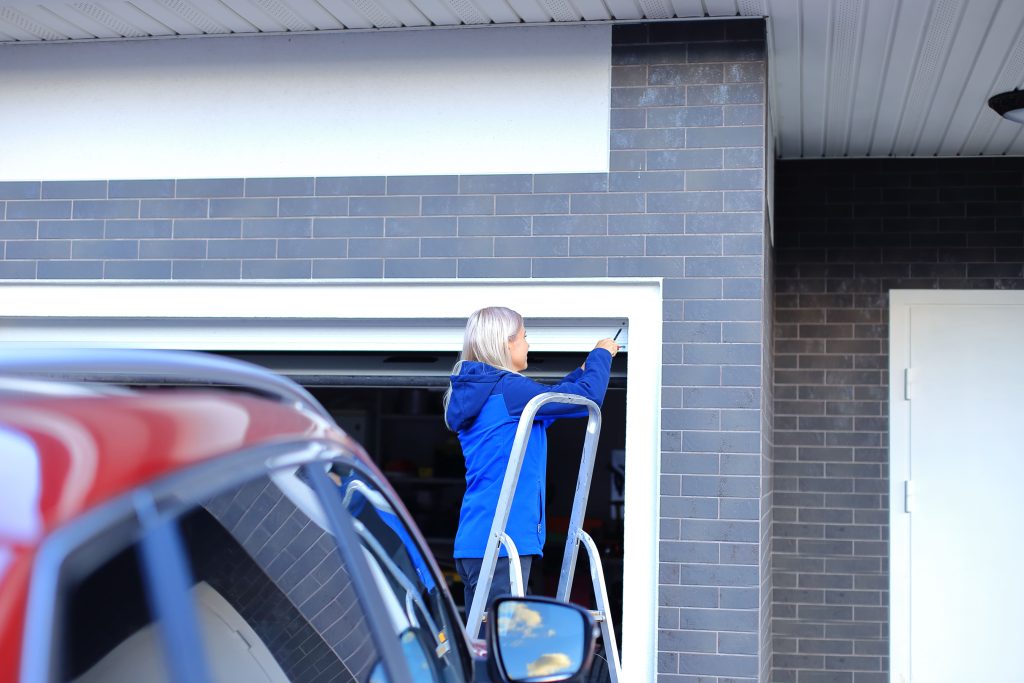 woman fixing garage door