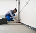 Garage Door Installation And Repair At Home. Contractor Man