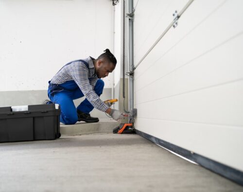 Garage Door Installation And Repair At Home. Contractor Man
