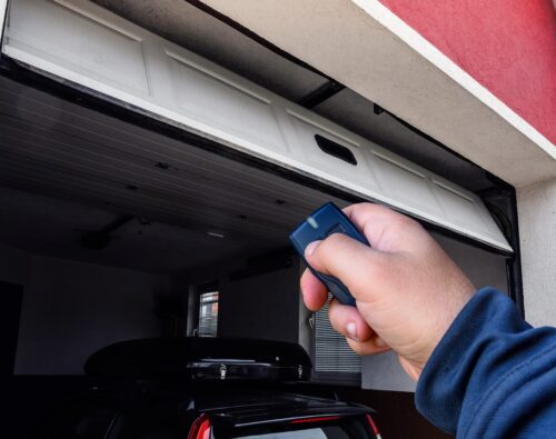 man holding the remote for the garage door
