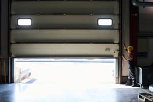 commercial garage door opening by worker