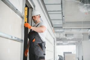 technician installing commercial garage door