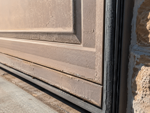 Peeling garage door with weathered textures
