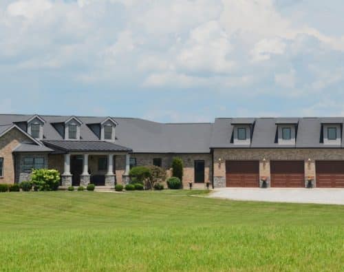 Home with multiple garage doors on a large property